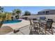 Outdoor dining area near the pool featuring a table, grill, and seating for outdoor relaxation at 2417 W Apache Rain Rd, Phoenix, AZ 85085