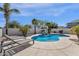 Relaxing lounge chairs are positioned near the private pool and rock waterfall feature in the backyard at 2417 W Apache Rain Rd, Phoenix, AZ 85085