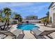 Private pool features a rock waterfall and is complemented by desert landscaping and a privacy wall at 2417 W Apache Rain Rd, Phoenix, AZ 85085