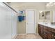 The bathroom features a glass-enclosed shower, dual sinks with wood cabinets, and neutral tones at 2512 E Vermont Dr, Gilbert, AZ 85295