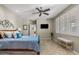 Bright bedroom with a ceiling fan and white plantation shutters, creating a cozy space for relaxation at 2512 E Vermont Dr, Gilbert, AZ 85295