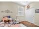 Charming bedroom with wood-look floors, a ceiling fan, and a window with plantation shutters features a closet at 2512 E Vermont Dr, Gilbert, AZ 85295