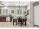 Bright dining area adjacent to kitchen features a modern chandelier and plantation shutters at 2512 E Vermont Dr, Gilbert, AZ 85295