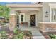 Charming front porch features decorative iron door, bench, stacked stone accents, and well-maintained landscaping at 2512 E Vermont Dr, Gilbert, AZ 85295