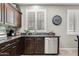 Well-appointed kitchen area features dark cabinets, stainless steel appliances, granite countertops, and plantation shutters at 2512 E Vermont Dr, Gilbert, AZ 85295