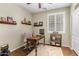 Home office features wood-look floors, a comfortable chair, and natural light from a window with shutters at 2512 E Vermont Dr, Gilbert, AZ 85295