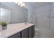 Well-lit bathroom featuring a vanity, a large mirror, shower over tub, and neutral-toned flooring at 30116 W Fairmount Ave, Buckeye, AZ 85396