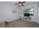 Bright bedroom featuring a window, carpet floors, a ceiling fan, and closet at 30116 W Fairmount Ave, Buckeye, AZ 85396