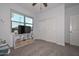 Bright bedroom featuring a window, carpet floors, a ceiling fan, and closet at 30116 W Fairmount Ave, Buckeye, AZ 85396