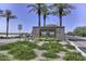 Stone Tartesso community sign surrounded by lush landscaping and towering palm trees on a clear day at 30116 W Fairmount Ave, Buckeye, AZ 85396