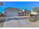 Charming single-story home featuring stone accents, a two-car garage, and low maintenance desert landscaping at 30116 W Fairmount Ave, Buckeye, AZ 85396