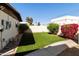 Exterior view of backyard featuring low maintenance lawn, patio, and partial wall at 322 W Laguna Dr, Tempe, AZ 85282