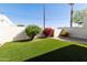 Exterior view of backyard featuring low maintenance lawn and partial wall at 322 W Laguna Dr, Tempe, AZ 85282