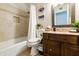 Neutral bathroom featuring a tub/shower combo with tile surround, toilet, and dark wood vanity at 322 W Laguna Dr, Tempe, AZ 85282