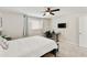 Bedroom featuring neutral walls, ceiling fan, a large window, and a desk at 322 W Laguna Dr, Tempe, AZ 85282