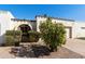 Charming single-story house with decorative ironwork, white stucco, and a lush, green citrus tree in the front yard at 322 W Laguna Dr, Tempe, AZ 85282