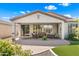 Home's back patio area featuring pavers, ample seating, decorative potted plants, and access to the home's interior at 4542 E Carob Dr, Gilbert, AZ 85298