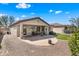 Exterior view of the home's covered back patio, low-maintenance landscaping, and overall backyard design at 4542 E Carob Dr, Gilbert, AZ 85298