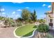 Backyard with artificial turf, desert landscaping, a gravel perimeter, and a view of the home's back patio at 4542 E Carob Dr, Gilbert, AZ 85298