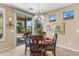 Charming dining area with a wooden table, chandelier, and sliding glass doors leading to the outdoors at 4542 E Carob Dr, Gilbert, AZ 85298