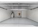 Spacious and clean garage with epoxy floors, overhead lighting, and ample storage space perfect for vehicles and projects at 4542 E Carob Dr, Gilbert, AZ 85298