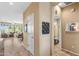 Hallway with neutral paint leading to a bathroom and an open concept kitchen and living area at 4542 E Carob Dr, Gilbert, AZ 85298