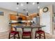 Modern kitchen featuring granite countertops, stainless steel appliances, and a breakfast bar with seating at 4542 E Carob Dr, Gilbert, AZ 85298