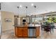 Open-concept kitchen flowing into a living and dining area with large windows and tile flooring at 4542 E Carob Dr, Gilbert, AZ 85298