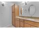 Bathroom featuring a double vanity with granite countertops and built-in storage at 5165 E Tunder Dr, Phoenix, AZ 85044