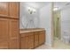 Bathroom featuring a double vanity with granite countertops and a tiled shower at 5165 E Tunder Dr, Phoenix, AZ 85044