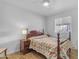 Cozy bedroom featuring a full bed, ceiling fan, a window offering natural light, and wood look flooring at 5165 E Tunder Dr, Phoenix, AZ 85044