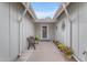 Welcoming entryway with seating, desert landscaping, and a decorative sunburst wall hanging at 5165 E Tunder Dr, Phoenix, AZ 85044