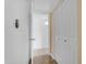 Hallway featuring white walls, wood-look floors, closet and views to another room at 5165 E Tunder Dr, Phoenix, AZ 85044