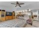 Open-concept living area featuring kitchen bar, neutral decor, and wooden entertainment center at 5165 E Tunder Dr, Phoenix, AZ 85044