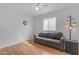 Bright living room with wood floors, white walls, ceiling fan, and modern lighting at 5165 E Tunder Dr, Phoenix, AZ 85044