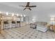 Open-concept living area with kitchen bar, modern lighting, neutral tones and tile flooring at 5165 E Tunder Dr, Phoenix, AZ 85044