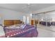 Spacious main bedroom with tile floors, ceiling fan, and mirrored closet doors at 5165 E Tunder Dr, Phoenix, AZ 85044