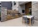 Stylish outdoor kitchen featuring stainless steel grills, a dining table, and modern seating for outdoor dining at 5250 E Deer Valley Dr # 343, Phoenix, AZ 85054