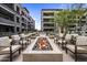 Cozy outdoor seating area with modern chairs surrounding a fire pit in a landscaped community at 5250 E Deer Valley Dr # 343, Phoenix, AZ 85054