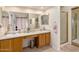 Bathroom with a double sink vanity, large mirror, and a glass-enclosed shower for a modern and functional space at 5471 W Quail Ave, Glendale, AZ 85308