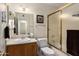 Cozy bathroom featuring a vanity with a sink, toilet and shower with glass door at 5471 W Quail Ave, Glendale, AZ 85308