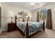 Bedroom featuring a decorative metal bedframe, arched windows, and neutral tones for a calming retreat at 5471 W Quail Ave, Glendale, AZ 85308