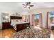 Spacious bedroom boasting a vaulted ceiling, wood floors, and a sliding glass door to a balcony with scenic views at 5471 W Quail Ave, Glendale, AZ 85308