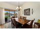 Elegant dining room with scenic lake views through sliding glass doors at 5471 W Quail Ave, Glendale, AZ 85308