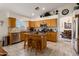 Bright kitchen featuring granite countertops, stainless steel appliances, and a central island with seating at 5471 W Quail Ave, Glendale, AZ 85308