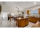 Open kitchen with island, granite counters and eat in dining area overlooking the living room with fireplace at 5471 W Quail Ave, Glendale, AZ 85308