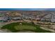 Aerial view of a residential area and desert landscape, complete with a golf course at 5644 N 206Th Gln, Buckeye, AZ 85396