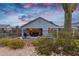 Backyard features a pool, fire pit and desert landscaping, framed by a secure wrought iron fence at 5644 N 206Th Gln, Buckeye, AZ 85396