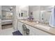 Bathroom featuring dual sinks with neutral countertops, vanity area, and walk-in glass shower at 5644 N 206Th Gln, Buckeye, AZ 85396