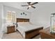 Cozy bedroom featuring wood furniture, a ceiling fan, and natural light from window at 5644 N 206Th Gln, Buckeye, AZ 85396